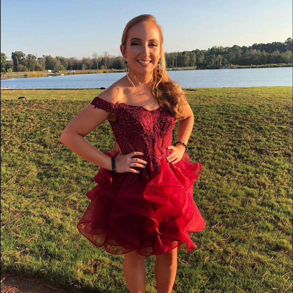 A maroon off the shoulder semi dress.
